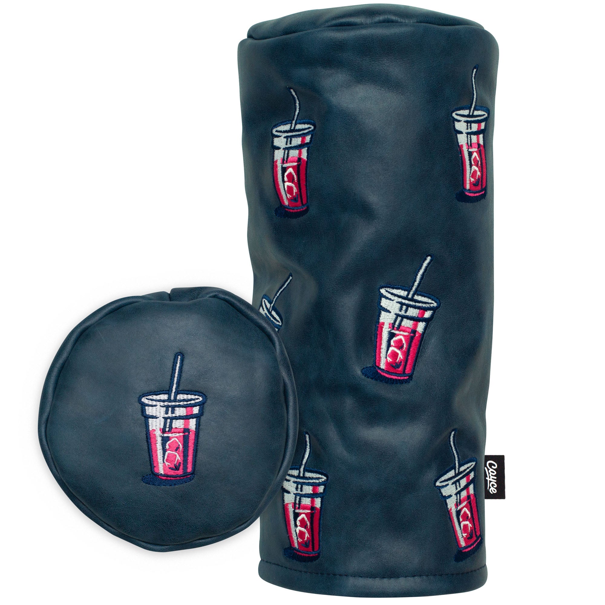 navy, barrel-shaped, full grain leather golf head cover standing on a white background. The head cover has a scattered embroidered pink transfusion drink pattern all over.