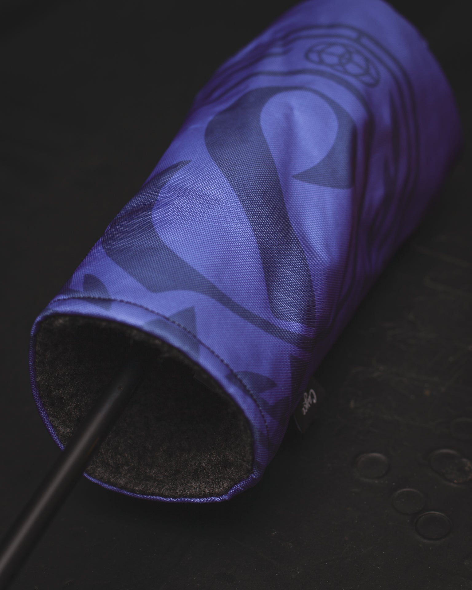 custom golf head cover close up image showing Cayce's DURA+ outer shell with the plush charcoal inner lining laying on a desk. (3690913595471)