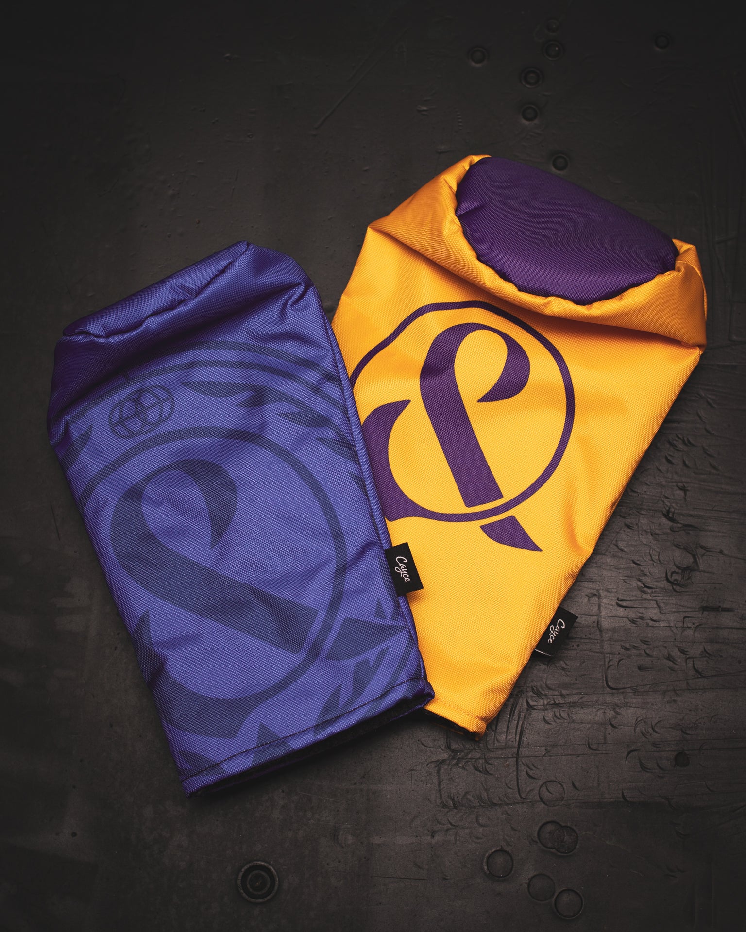 Custom headcovers for the band Of Mice & Men. Custom fairway wood features a subtle dark purple ampersand on a purple background. Custom driver head cover is Lakers yellow and purple. (3690913595471)