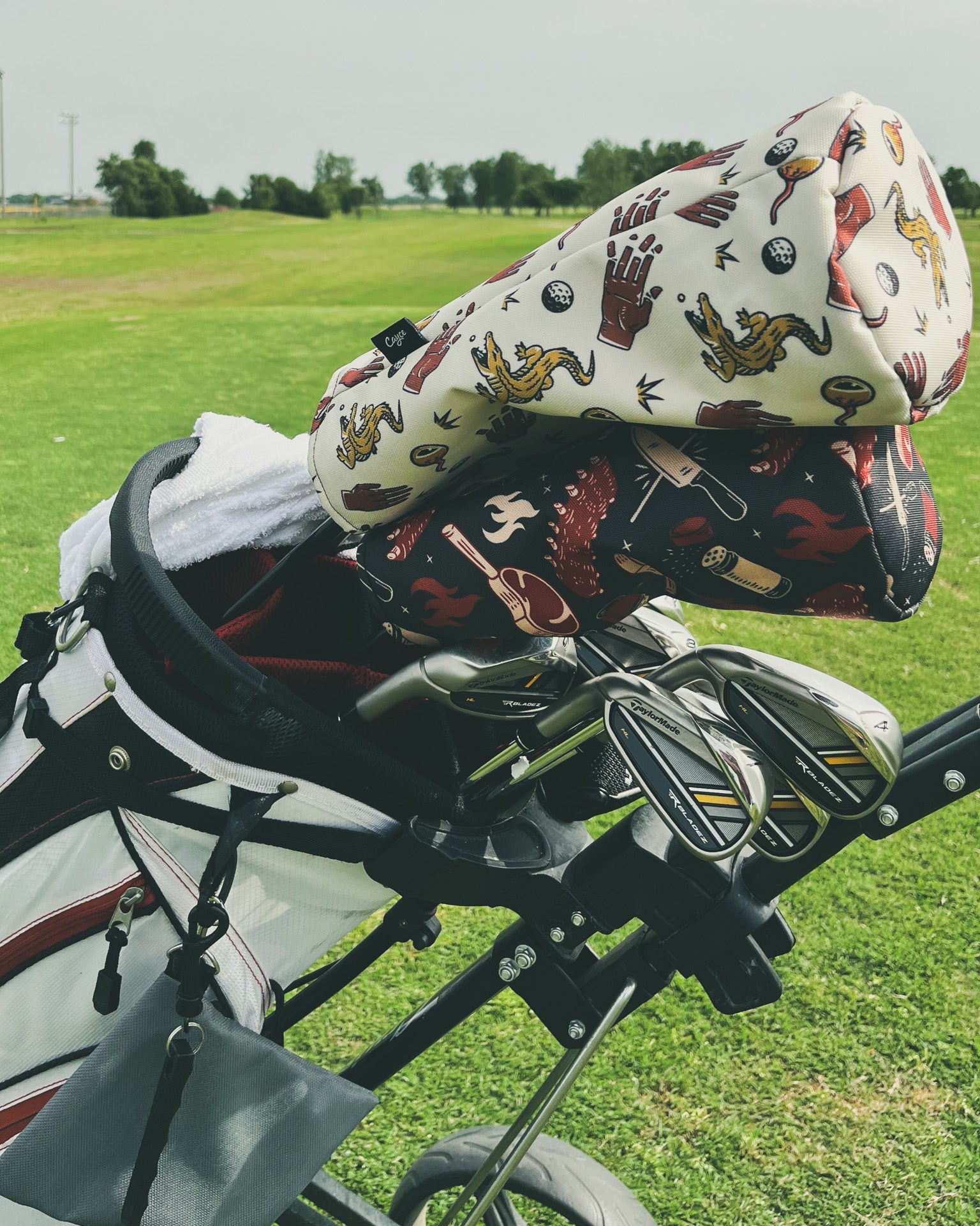 a set of golf clubs with a Chubbs driver head cover from Cayce golf. 