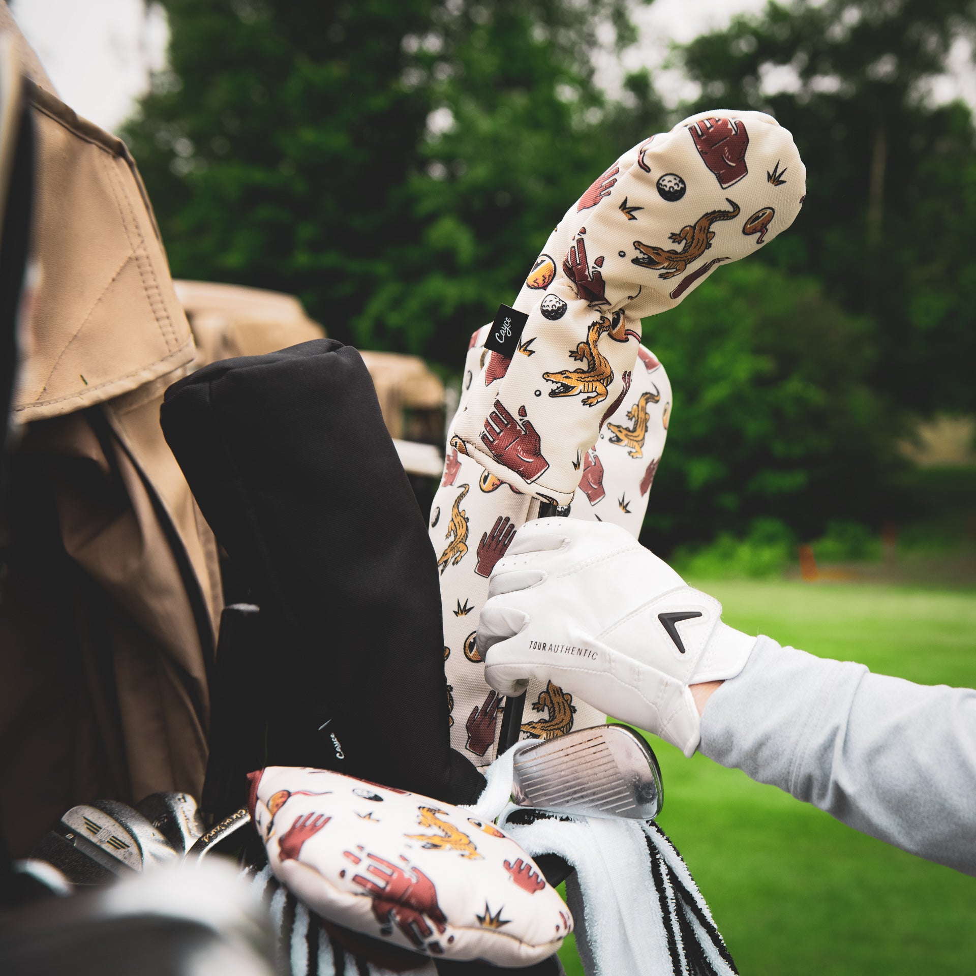 Golfer pulling a club out of his golf bag with chubbs protective golf head covers