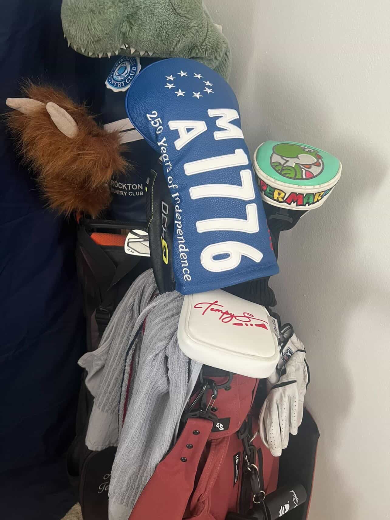 maroon golf bag with a Massachusetts 250th Anniversary License Plate Golf Head Cover form Cayce Golf