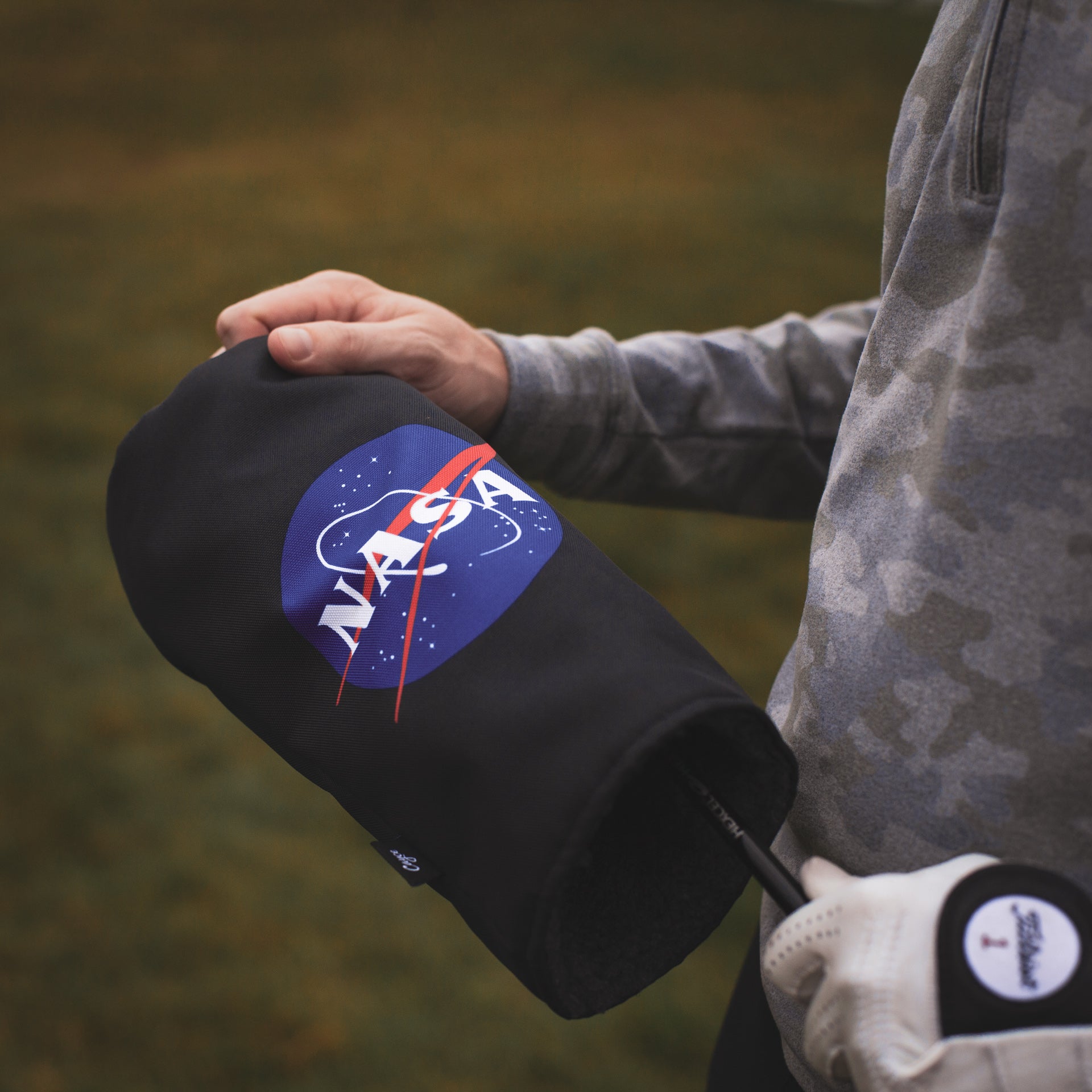 golfer pulling off a custom NASA golf headcover from Cayce Golf