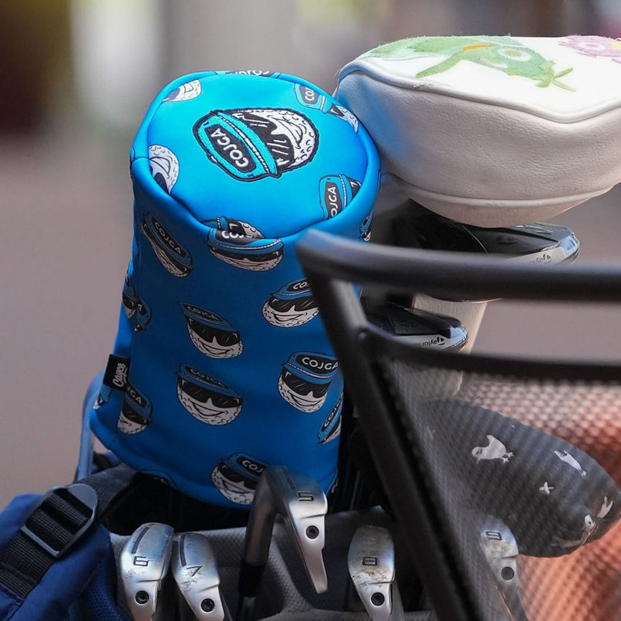 blue custom driver head cover with dancing golf ball logos and embroidered top cap logo from cayce golf