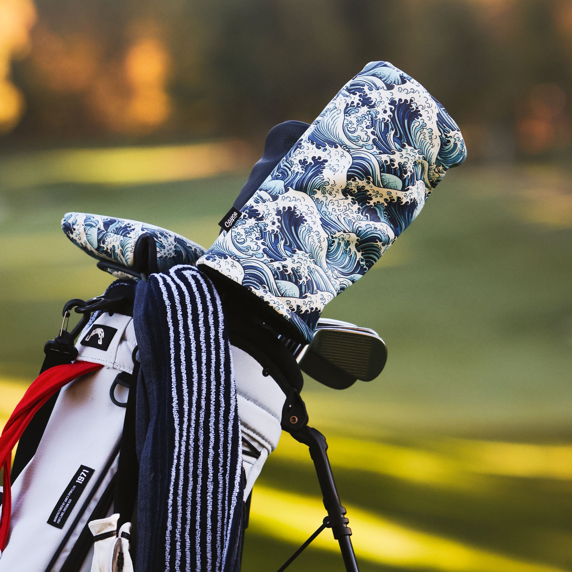japanese wave driver head cover in a golf bag on a golf course