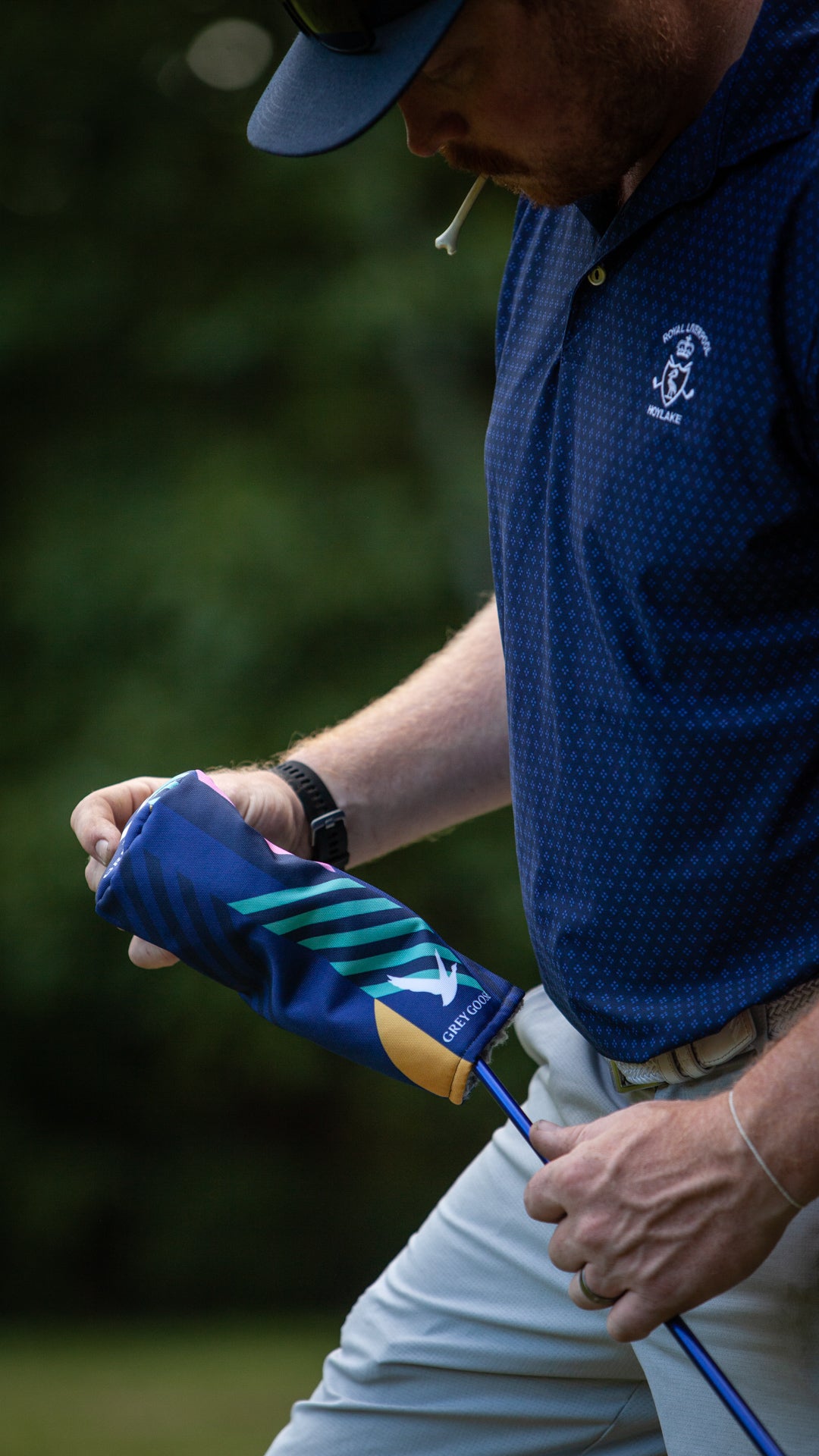 golfer pulling off a custom designed Grey Goose golf fairway wood headcover