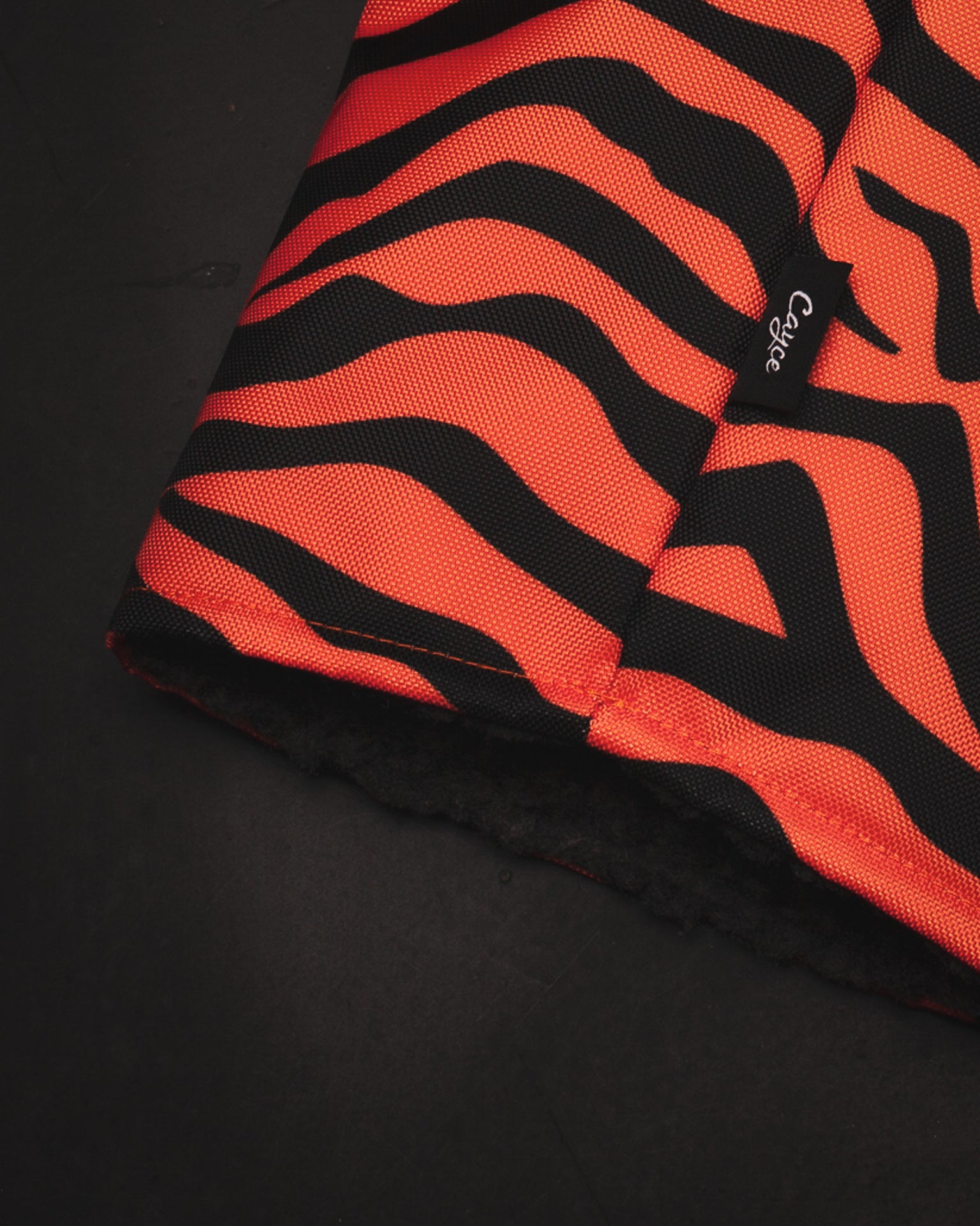 Close up view of the G.O.A.T. DURA+ golf headcover from Cayce Golf featuring a brilliant Tiger Stripe Design and plush charcoal lining (4308881899599)