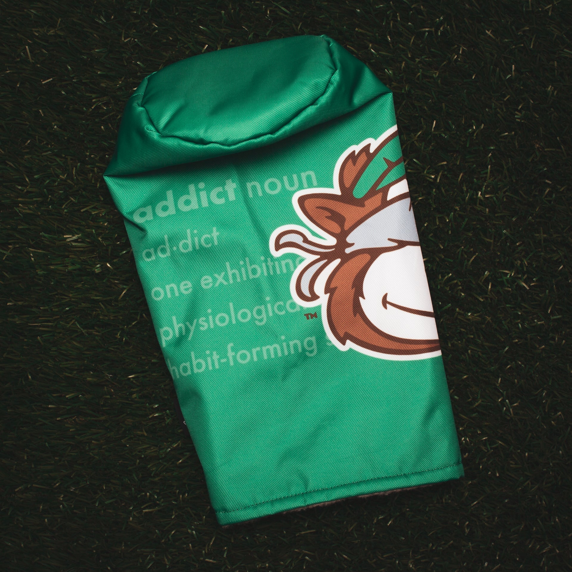 Custom golf headcovers for Tour Junkies. This green driver headcover features their mascot Golby overlaying a ghosted "addict" definition in the background. (3690913595471)