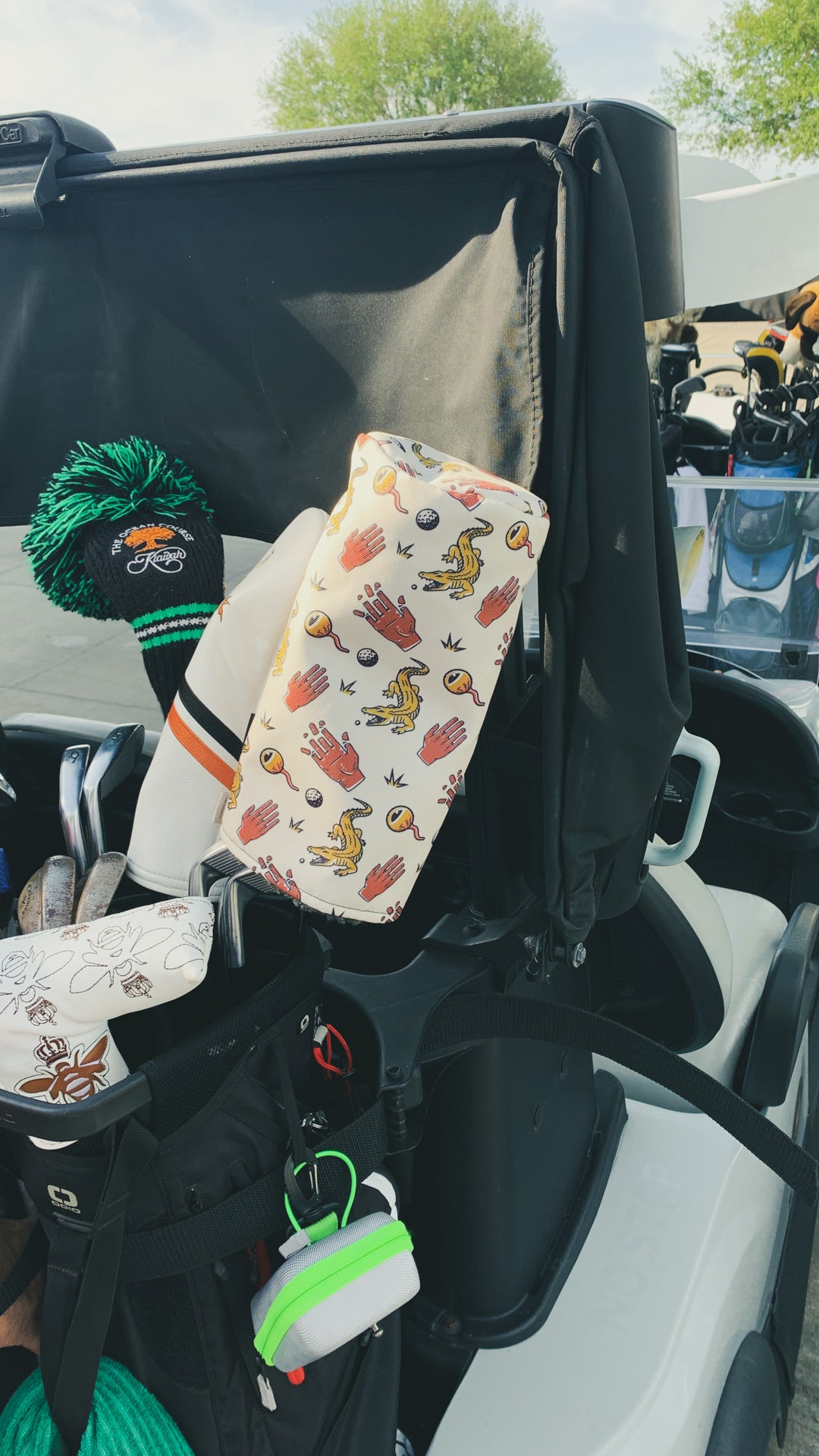 chubbs driver head cover from cayce golf in the back of a golf cart