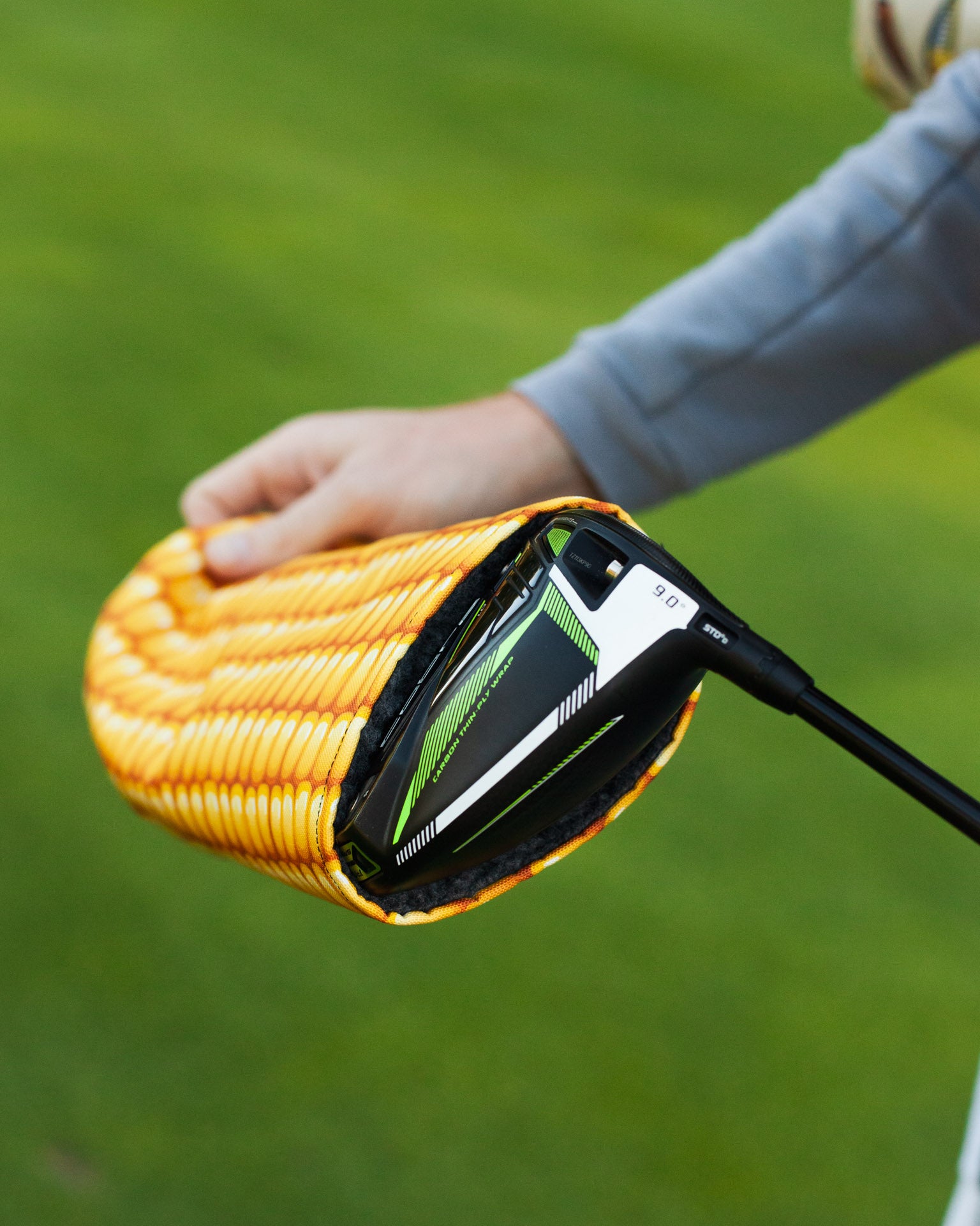 golfer removing his corn driver head cover 